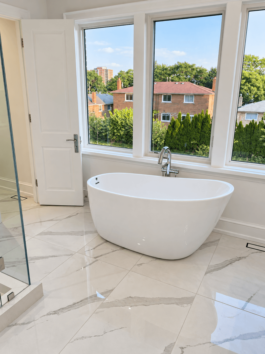 Freestanding bathtub and tile finishes in a residential bathroom